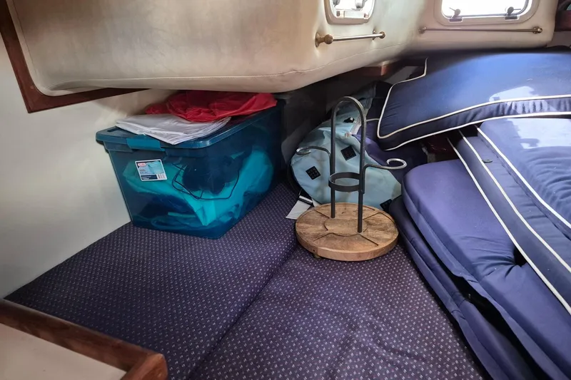Slide: The Image of Cozy cabin interior of 1992 Pacific Seacraft Ericson 34 with storage and cushions. - 37