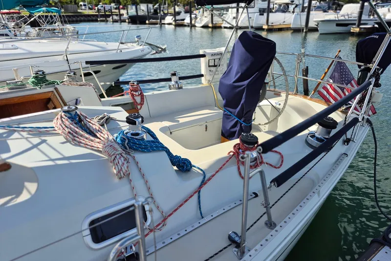 Slide: The Image of 1992 Pacific Seacraft Ericson 34 sailboat docked, featuring ropes and American flag. - 4