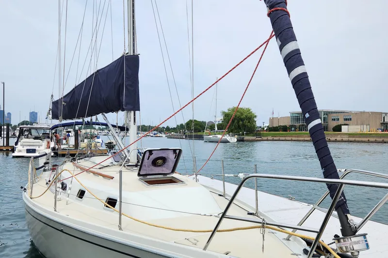 Slide: The Image of 1992 Pacific Seacraft Ericson 34-2 sailboat docked in a marina, calm waters, clear sky. - 6