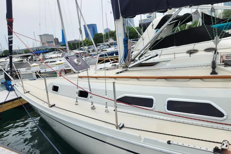 Slide: The Image of 1992 Pacific Seacraft Ericson 34-2 sailboat docked in a marina, surrounded by other boats. - 7
