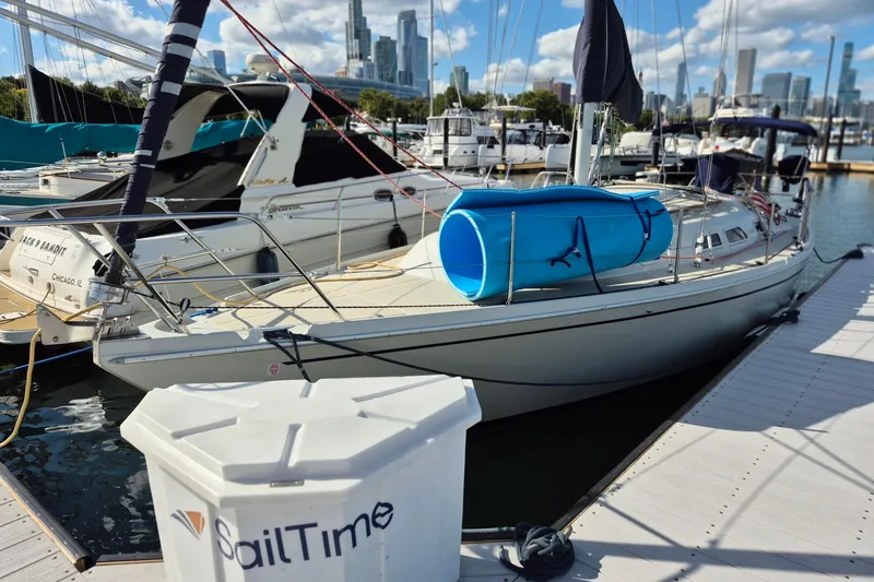 Slide: The Image of 1992 Pacific Seacraft Ericson 34 sailboat docked at marina with city skyline. - 8
