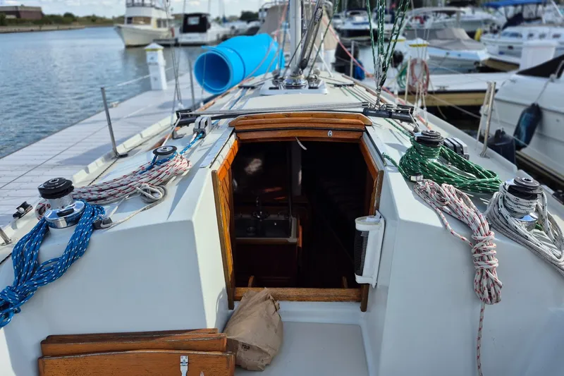 Slide: The Image of 1992 Pacific Seacraft Ericson 34 sailboat cockpit with ropes and open cabin entrance. - 9