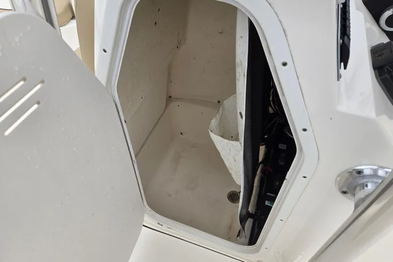 Slide: The Image of Open storage compartment in 2018 Key West 203 FS boat, showing interior space and wiring. - 12