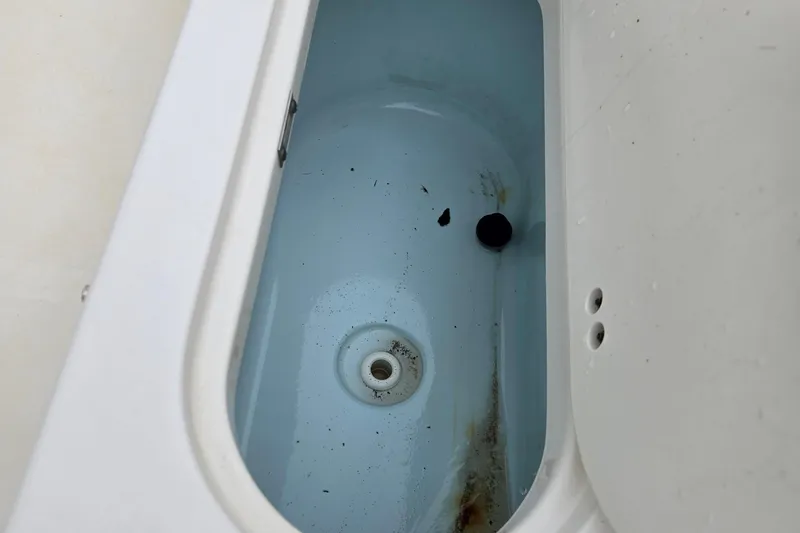 Slide: The Image of 2018 Key West 203 FS boat livewell interior with drain and slight discoloration. - 14