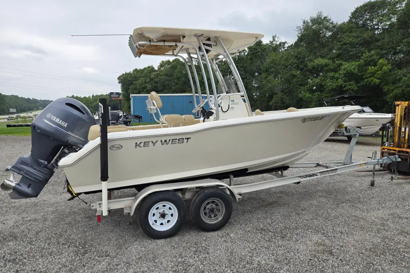 Slide: The Image of 2018 Key West 203 FS boat on trailer with Yamaha outboard motor, parked outdoors. - 3