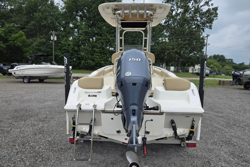 Slide: The Image of 2018 Key West 203 FS boat with Yamaha 150 engine, parked outdoors. - 5