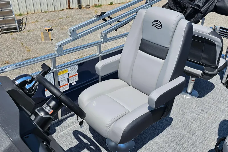 Slide: The Image of 2026 Sun Tracker SportFish 20 DLX boat interior with comfortable captain's chair and steering wheel. - 12