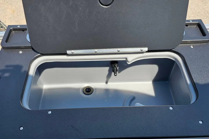 Slide: The Image of Livewell compartment on 2026 Sun Tracker SportFish 20 DLX boat, open lid view. - 21