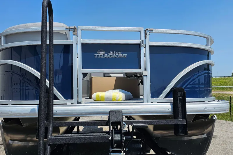 Slide: The Image of 2026 Sun Tracker SportFish 20 DLX pontoon boat, blue exterior, docked outdoors. - 4