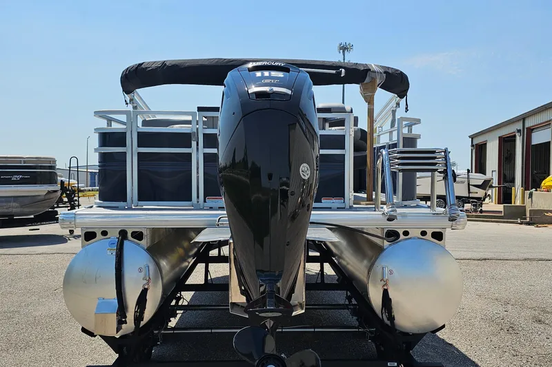 Slide: The Image of 2026 Sun Tracker SportFish 20 DLX pontoon boat with powerful outboard motor, docked outdoors. - 5