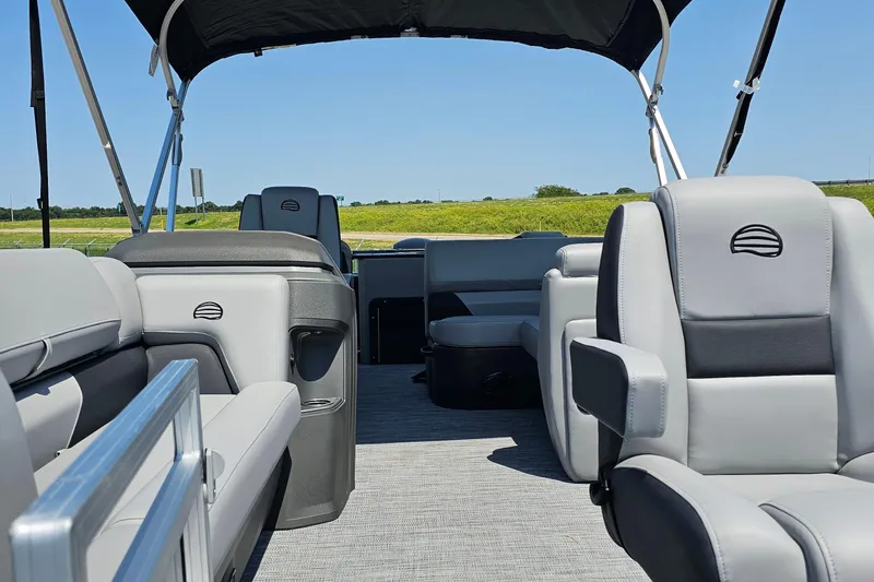 Slide: The Image of 2026 Sun Tracker SportFish 20 DLX pontoon boat interior with gray seating and canopy. - 6