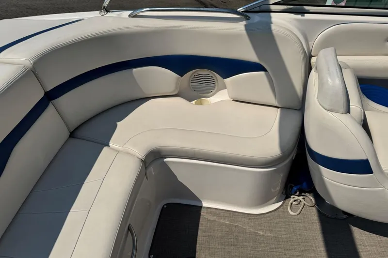 Slide: The Image of 2001 Chaparral 220 SSi boat interior with white and blue seating, cup holder, and speaker. - 10