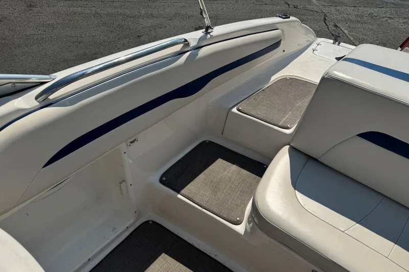 Slide: The Image of 2001 Chaparral 220 SSi boat interior with white and blue seating and flooring. - 11