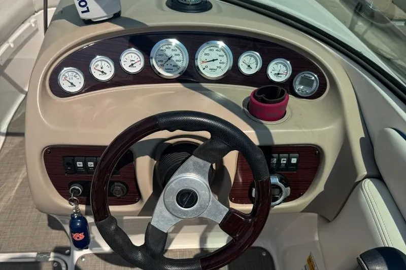Slide: The Image of Dashboard of a 2001 Chaparral 220 SSi boat with gauges and steering wheel. - 13