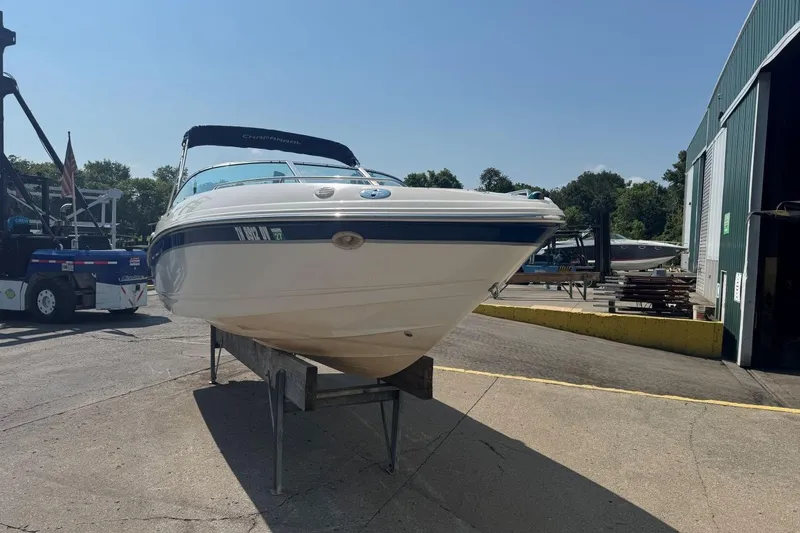 Slide: The Image of 2001 Chaparral 220 SSi boat on stand outside a storage facility. - 2