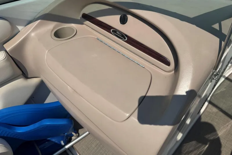Slide: The Image of 2001 Chaparral 220 SSi boat interior with beige dashboard and cup holder. - 21