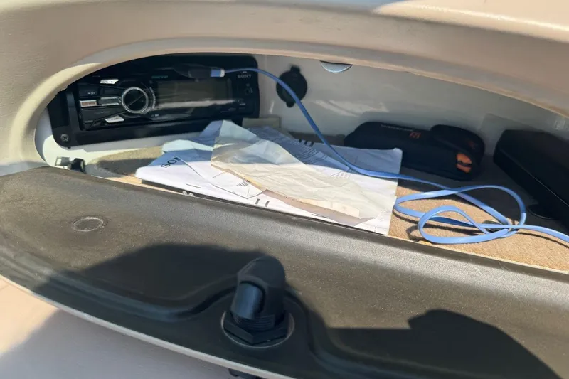 Slide: The Image of Storage compartment in a 2001 Chaparral 220 SSi boat with stereo and cables. - 22