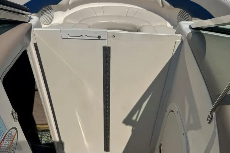 Slide: The Image of 2001 Chaparral 220 SSi boat interior with white seating and door. - 24