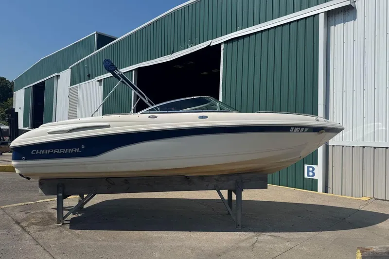Slide: The Image of Chaparral 220 SSi 2001 boat on display outside a green warehouse. - 4