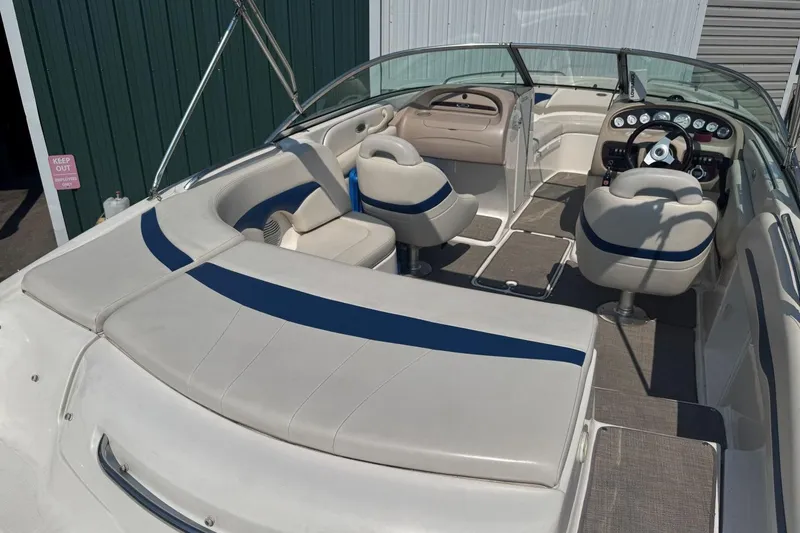Slide: The Image of 2001 Chaparral 220 SSi boat interior with white and blue seating, steering wheel, and dashboard. - 7