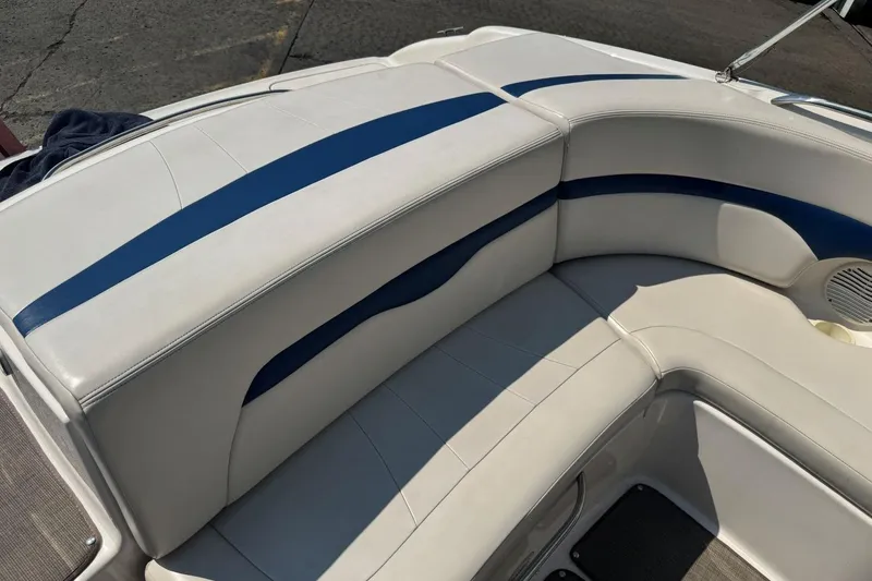 Slide: The Image of 2001 Chaparral 220 SSi boat interior with white and blue cushioned seating. - 9