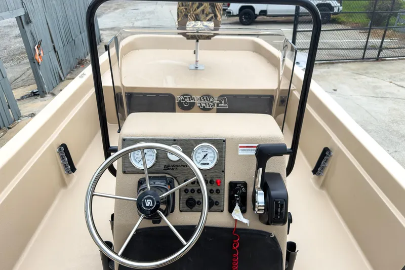 Slide: The Image of 2026 Carolina Skiff E21 DLX CC boat dashboard with steering wheel and controls. - 15