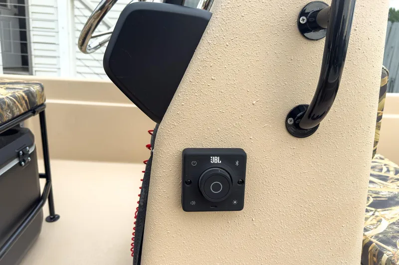 Slide: The Image of JBL audio control panel on 2026 Carolina Skiff E21 DLX CC boat console. - 16