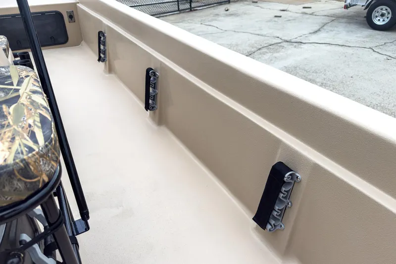 Slide: The Image of 2026 Carolina Skiff E21 DLX CC boat interior with camo seat and secure rod holders. - 20