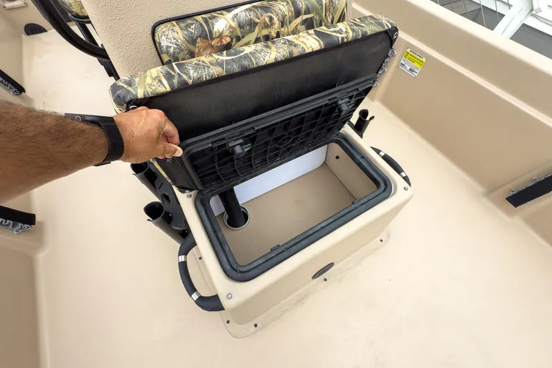 Slide: The Image of 2026 Carolina Skiff E21 DLX CC boat seat storage compartment being opened. - 25