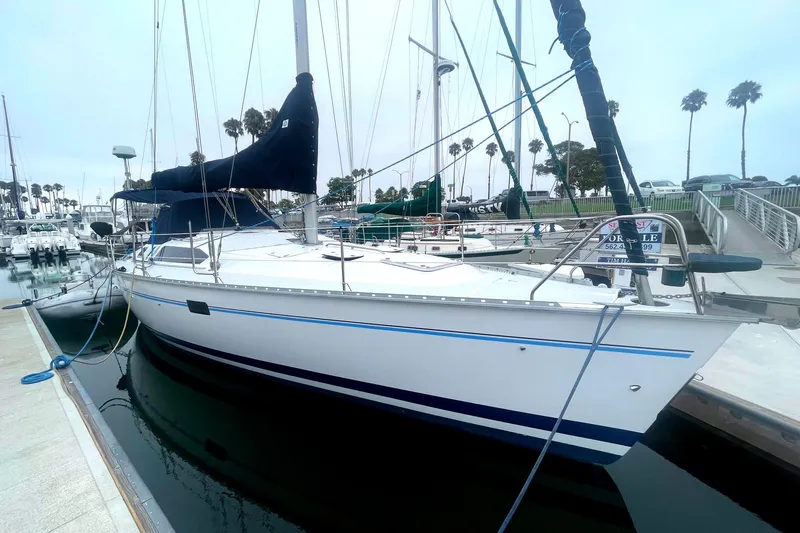 Slide: The Image of Sailboat Hunter 40.5, 1993 model, docked at marina with palm trees in background. - 12