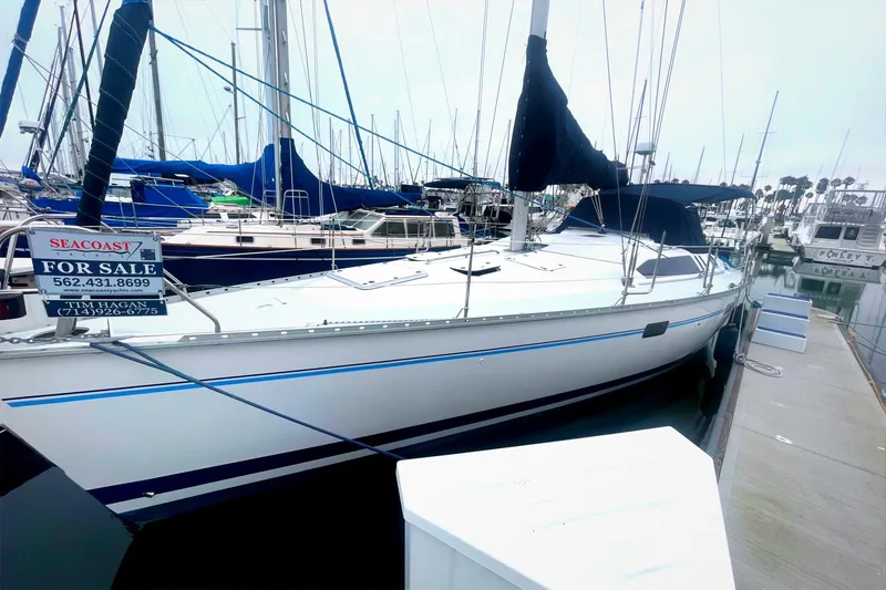 Slide: The Image of Sailboat for sale at marina, 1993 Hunter 40.5 model, docked with visible contact information. - 13
