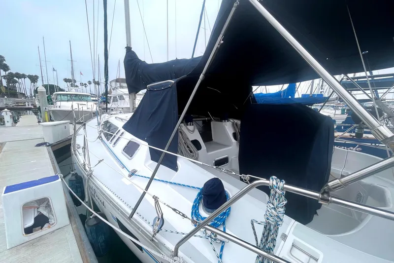 Slide: The Image of Sailboat docked at marina, 1993 Hunter 40.5 model, covered with navy blue canvas. - 14
