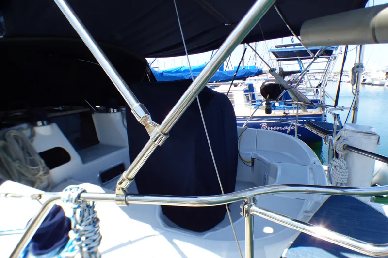 Slide: The Image of 1993 Hunter 40.5 sailboat cockpit with stainless steel railings in a marina setting. - 16