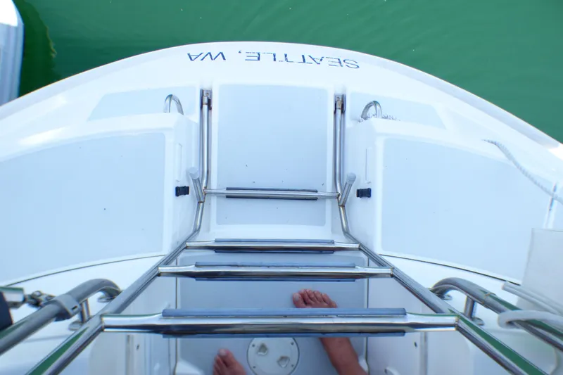 Slide: The Image of View from a 1993 Hunter 40.5 sailboat's stern ladder, overlooking green water. - 19
