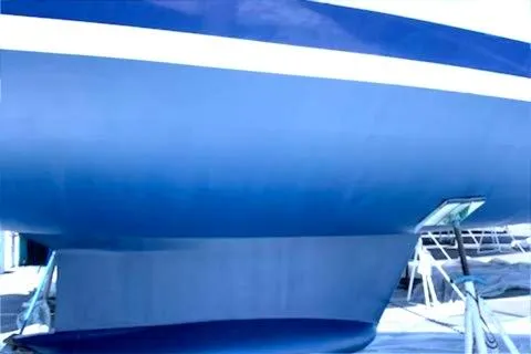 Slide: The Image of 1993 Hunter 40.5 sailboat hull in dry dock, showcasing sleek blue design. - 22