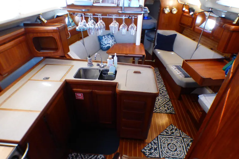 Slide: The Image of Interior of 1993 Hunter 40.5 sailboat with cozy seating and kitchen area. - 23