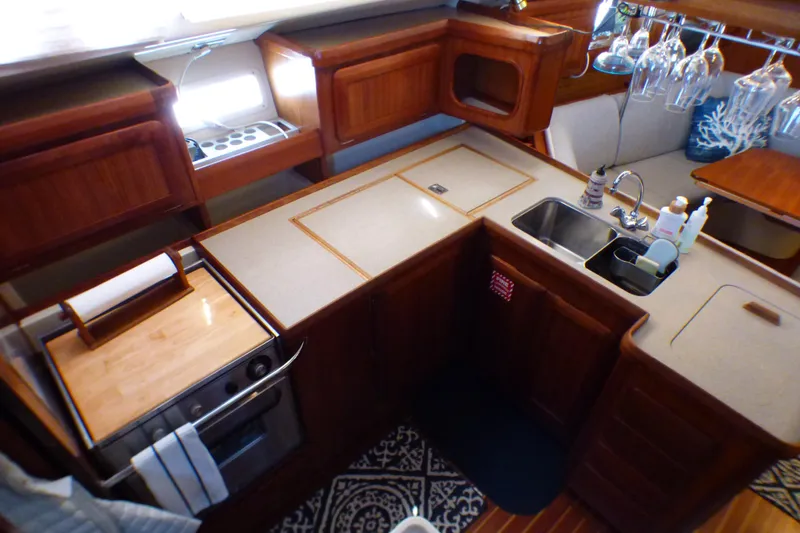 Slide: The Image of 1993 Hunter 40.5 yacht kitchen with wooden cabinetry, dual sink, and modern appliances. - 24