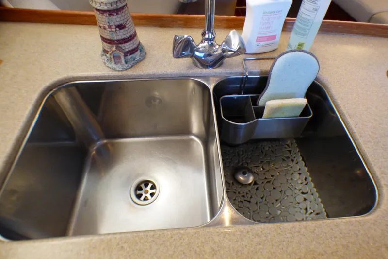 Slide: The Image of Stainless steel double sink with faucet and cleaning supplies on a 1993 Hunter 40.5 yacht. - 27