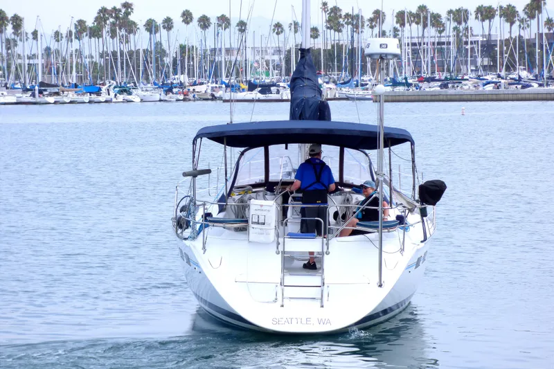 Slide: The Image of Sailboat "Hunter 40.5" from 1993 in marina, Seattle, WA, with palm trees in background. - 3