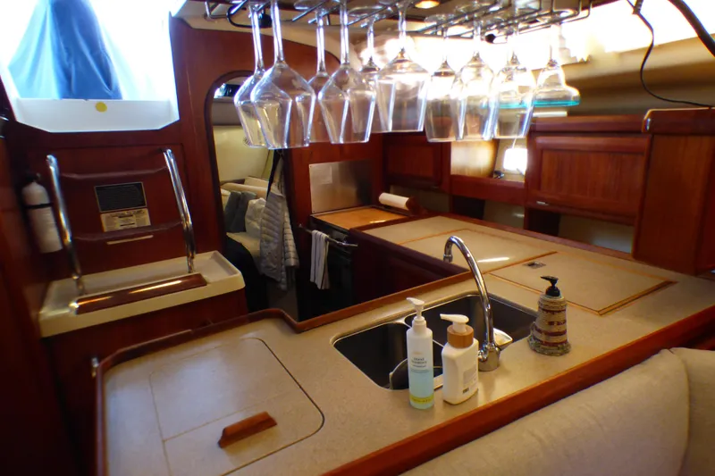 Slide: The Image of Luxurious 1993 Hunter 40.5 yacht interior with kitchen, sink, and hanging glassware. - 31