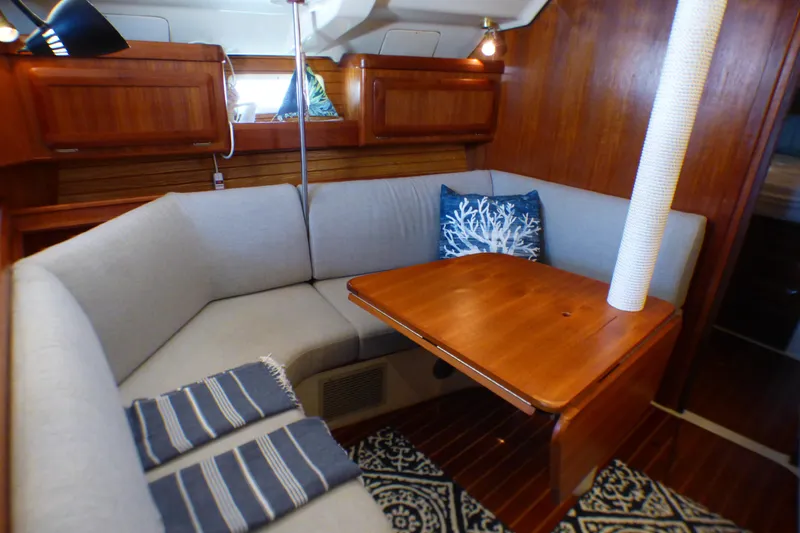 Slide: The Image of Cozy interior of 1993 Hunter 40.5 sailboat with wooden table and cushioned seating. - 33