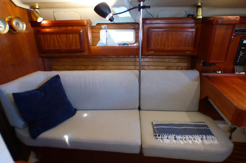 Slide: The Image of Cozy interior of 1993 Hunter 40.5 sailboat with sofa and wooden cabinetry. - 34