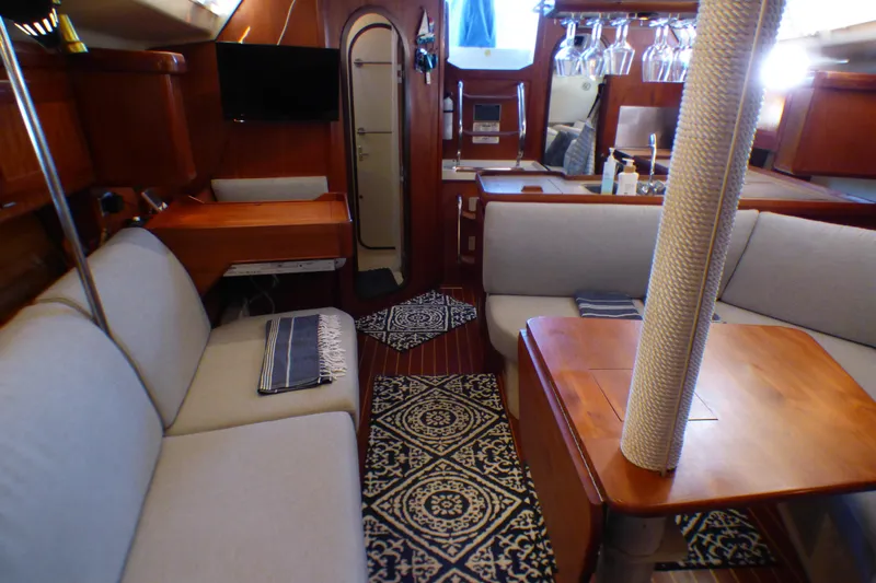 Slide: The Image of Interior of a 1993 Hunter 40.5 sailboat with cozy seating and elegant wood finishes. - 35