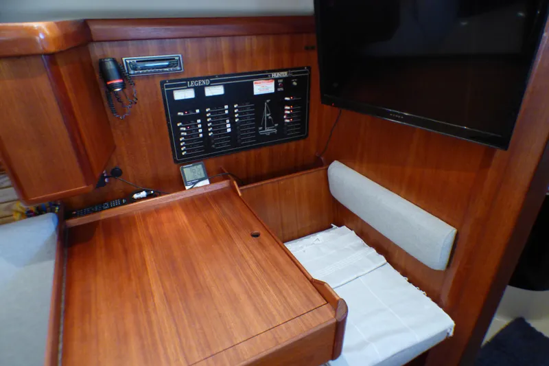 Slide: The Image of Navigation station of 1993 Hunter 40.5 sailboat with control panel and seating area. - 36