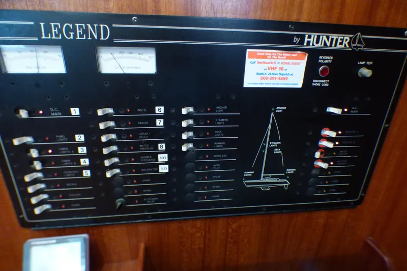 Slide: The Image of Control panel of a 1993 Hunter 40.5 sailboat with various switches and indicators. - 37