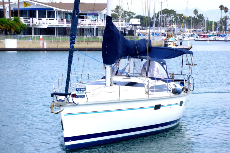 Slide: The Image of Sailboat Hunter 40.5, 1993 model, docked with "For Sale" sign, marina background. - 4