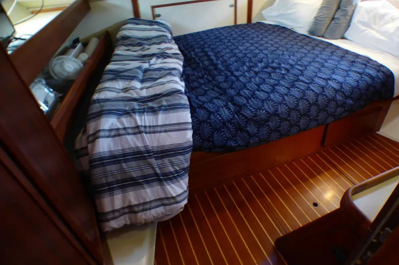 Slide: The Image of Cozy cabin interior of 1993 Hunter 40.5 sailboat with wooden flooring and comfortable bedding. - 44