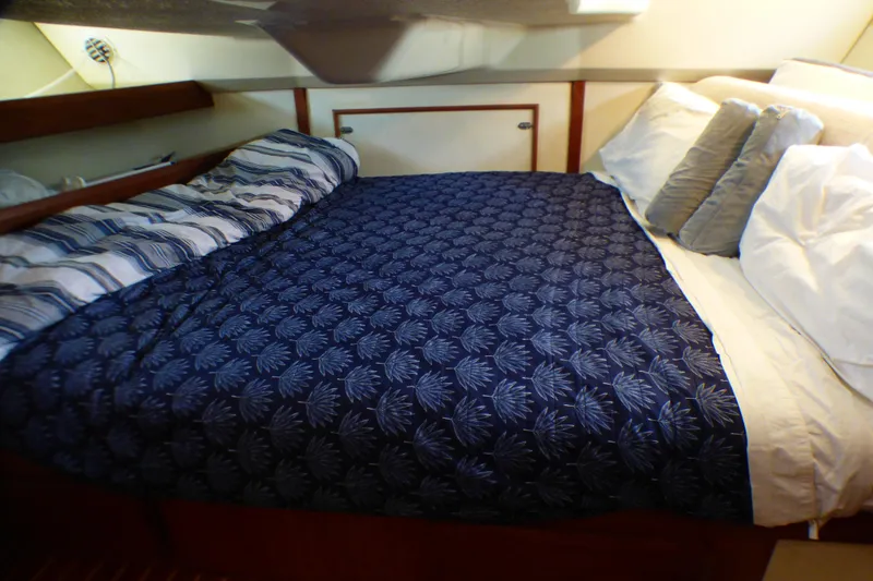 Slide: The Image of Cozy cabin bed in 1993 Hunter 40.5 sailboat with patterned bedding and pillows. - 46