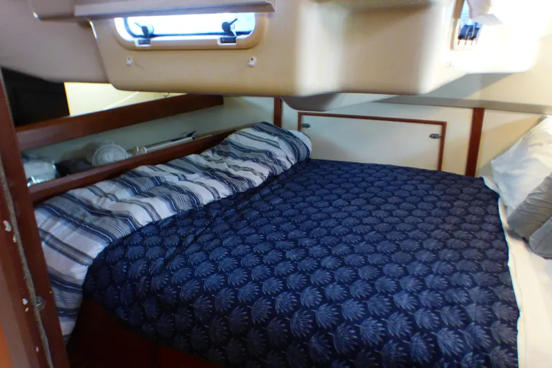 Slide: The Image of Cozy cabin interior of 1993 Hunter 40.5 sailboat with patterned bedding. - 47