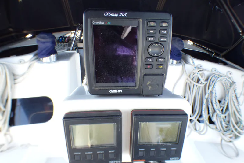 Slide: The Image of Garmin GPSmap 182C on 1993 Hunter 40.5 sailboat, with navigation instruments and ropes. - 49